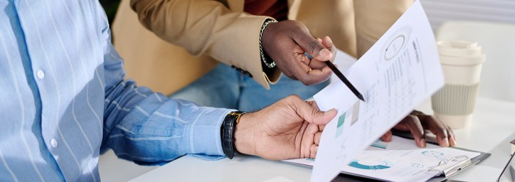 Two people looking at financial documents