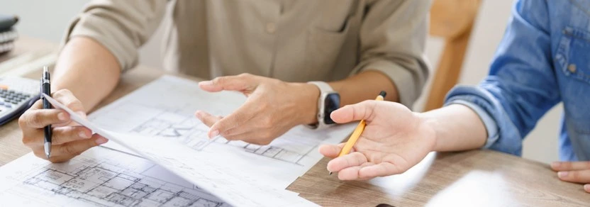 two people looking at blueprints