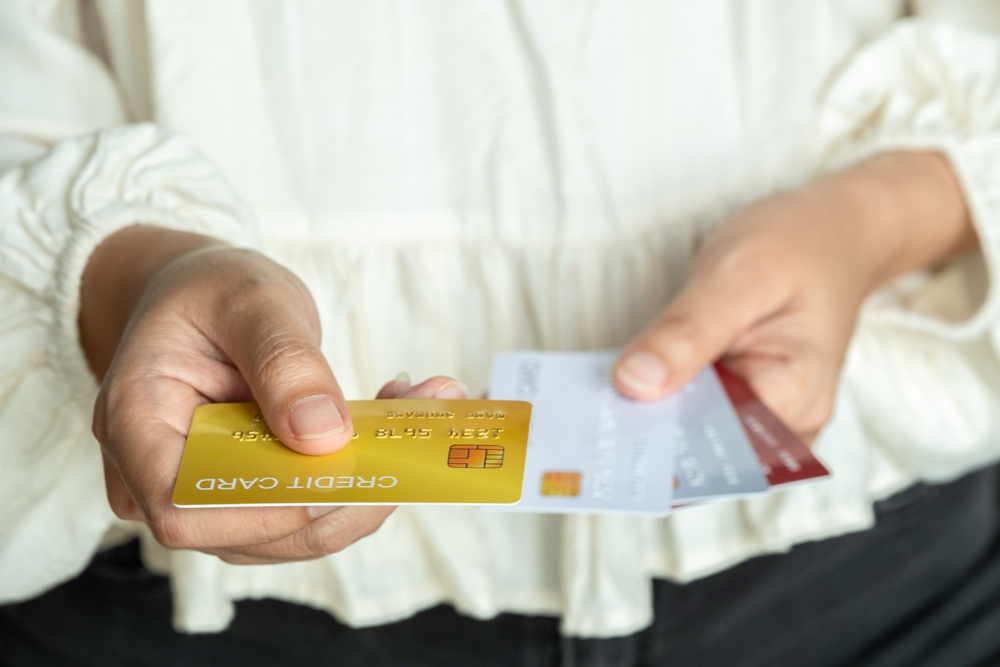 Image of hands holding credit cards