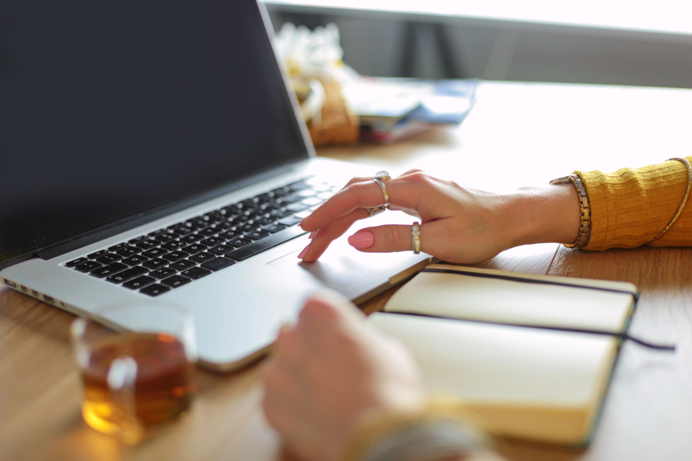 Close up of hands typing on laptop